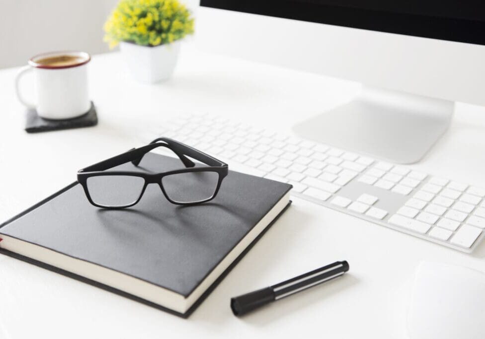 A pair of glasses sitting on top of a book.